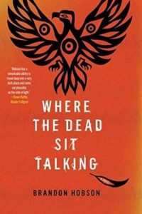 The cover of Where the Dead Sit Talking is orange-red with a black line drawing resembling a bird at the top.